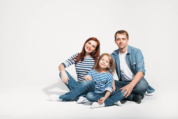 Happy family portrait sitting on white background isolated