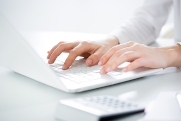 Closeup of businesswoman typing on laptop computer