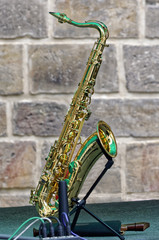 Saxophone and stone wall behind it