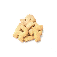 Closeup pile of brown biscuit in english alphabet isolated on white background
