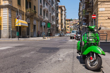 Fototapeta na wymiar reen vespa parking at Napoli street, Laspezia, Italy