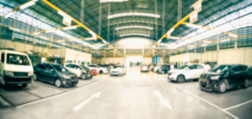 Car repair service centre in blurred background.