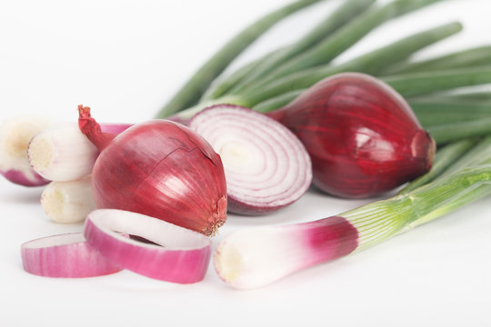 Onions. Red onion and spring onions on white background. Healthy food.