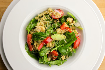 Quinoa salad with spinach, cherry tomatoes and chickpeas