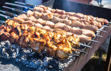 Juicy slices of meat with sauce prepare on the hot coals