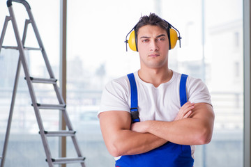 Worker with noise cancelling headphones
