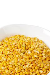 Dry yellow split peas isolated on white.
