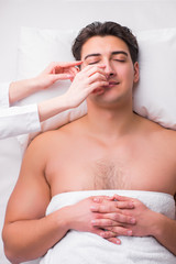 Handsome man in spa massage concept