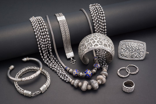 Collection of antique traditional silver jewelry on black paper