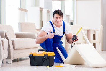 Furniture repairman working in store