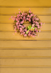 Pink flower wreath decorated for easter with bunny