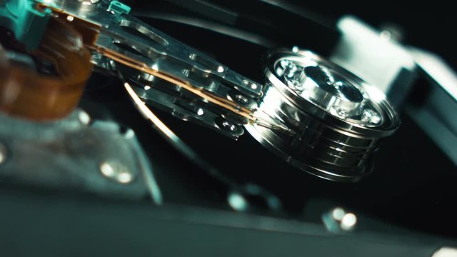 Storage of information, computer hdd. A close-up of the details of the hard drive, the spindle and the head. Electronics, computer technologies. artificial intelligence. Storage of large data objects