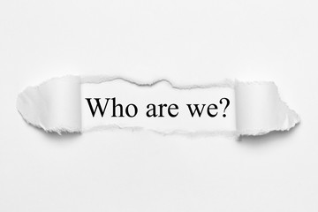 Who are we? on white torn paper