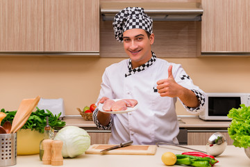 Young chef working in the kitchen