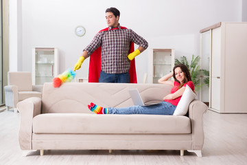 Obraz premium Superhero husband helping his wife at home