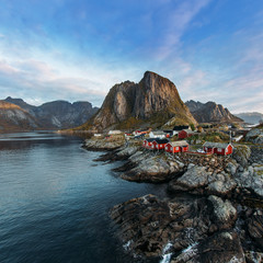 Fototapeta na wymiar Lofoten islands is an archipelago in the county of Nordland, Norway. Distinctive scenery with dramatic mountains and peaks, open sea and sheltered bays and red fishing huts, called rorbu.