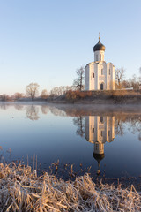 View to the Church of the Intercession of the Holy Virgin on the Nerl River in sunlight.