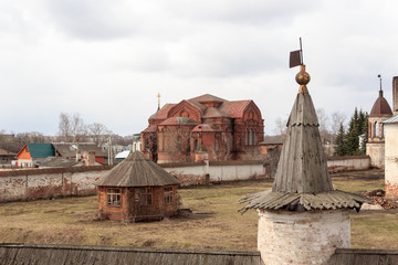 White-stone monastery with sky-blue domes at early spring