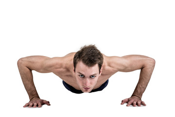 Obraz premium Healthy lifestyle and fitness. Beautiful guy sportive physique, with a naked body, push-up, isolated on a white background. Horizontal frame