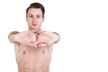 Fototapeta premium Healthy lifestyle. Portrait of a handsome guy with a sporty naked body, warming up, isolated on white background. Horizontal frame