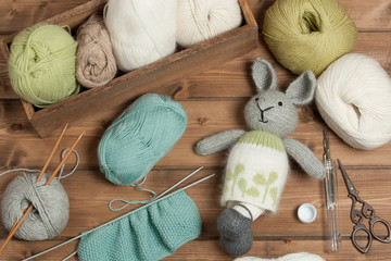 Handmade Knitted Rabbit Soft Toy. Yarn Balls. Wooden Knit Needles.