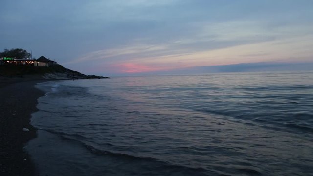 Waves gently wash up onto the beach, then recede as the sunset. A beautiful sunset over a sea on Turkey in duzce akcakoca 