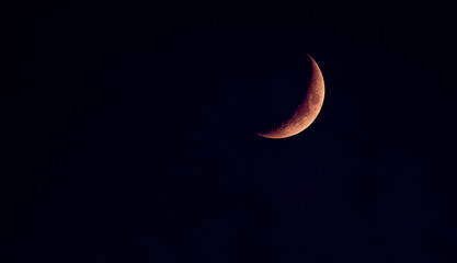 an elipsed moon with orange tinge