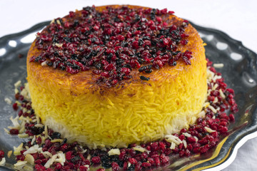 Traditional Iranian Rice Pie Tahdig Polo with Berberis on a tray