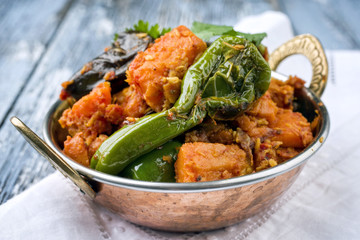 Indian Vegetable Curry Fry with Sweet Potatos and Eggplant as close-up in a Kadai