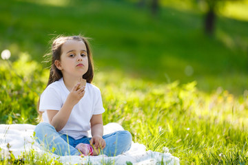 Child eating ice cream. Kids play outdoors enjoying sweet snack on a hot summer day. Children eat icecream. Toddler kid playing in the garden. Little girl with vanilla and chocolate ice cone.