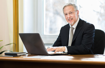 Smiling businessman in his office