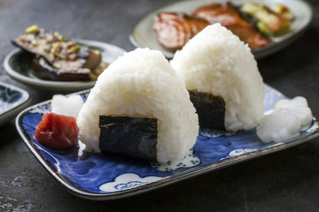 Traditional Japanese Onigiri with Umeboshi as garnish on a bowl