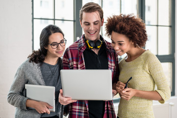 Young team looking over a business presentation on laptop in the office
