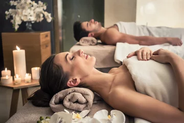 Papier Peint photo Salon de massage Man and woman lying down on massage beds at Asian wellness center