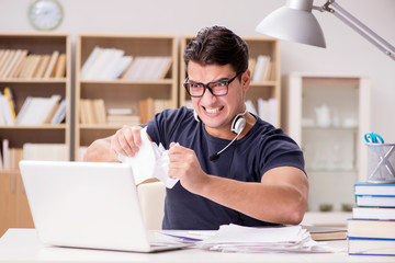 Angry man tearing apart his paperwork due to stress