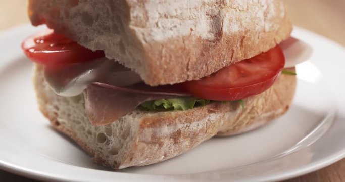 Slide macro shot of ciabatta sandwich with speck, mazzarella and vegetables, 4k 60fps prores footage