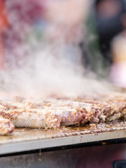 Cooking pork sausages in a street market