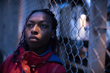 A portrait of a young, black woman with braids in Brooklyn, New York City. Shot in the streets...