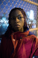 A portrait of a young, black woman with braids in Brooklyn, New York City. Shot in the streets...
