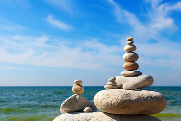 Concept of harmony and balance. Rock Zen on the background of summer sea