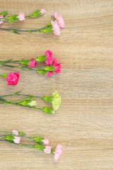 Flowers lie on a wooden surface and place for text.