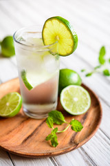 Refreshing lime drink with ice cubes in a glass jar