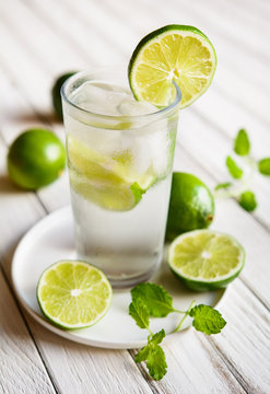 Refreshing lime drink with ice cubes in a glass jar