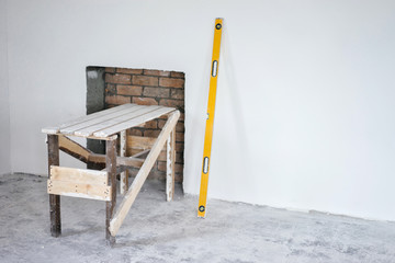 Construction grunge ladder, and the building yellow level : white wall and gray floor. Apartment decoration concept.