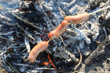 Three sausage fry on fire