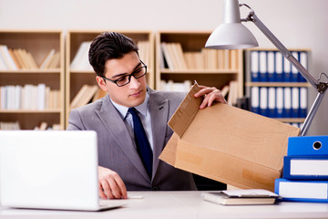 Businessman receiving parcel in office