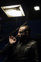 A middle aged, Arabic man lights a cigar in the streets of Brooklyn, New York City. Shot using ambient lighting during the sping of 2017.