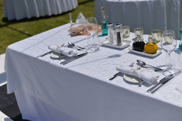 Catered service and tables ready for food eating event reception, busy light background