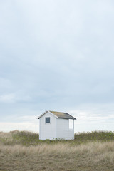 Fototapeta na wymiar Small beach hut down by the seashore