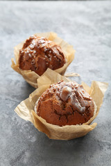Tasty muffins on grey wooden table